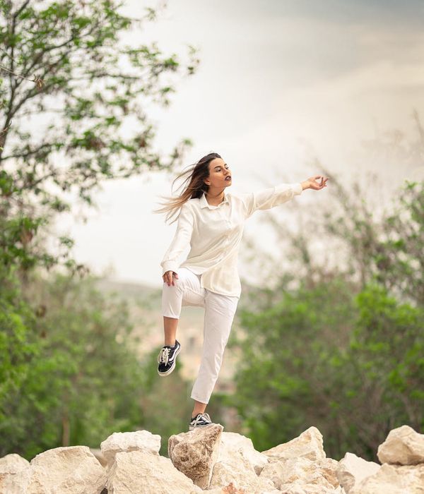 Woman in a graceful yoga pose representing fluid movement.